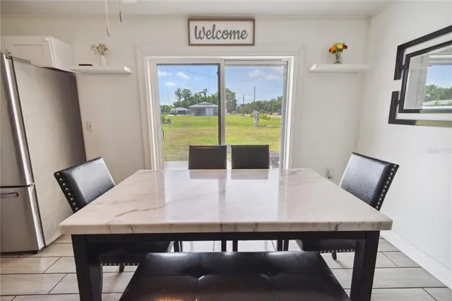a view of a dining room with furniture and a potted plant