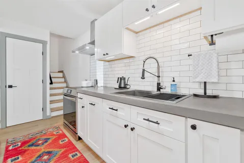 a spacious bathroom with a sink and a mirror