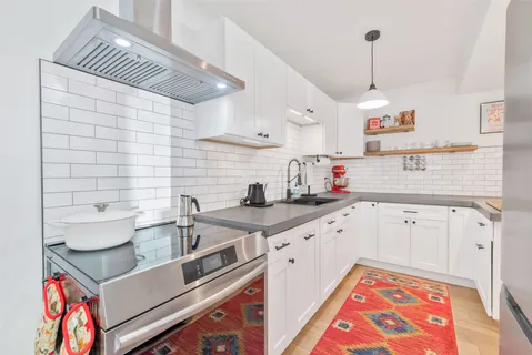 a kitchen with stainless steel appliances granite countertop a sink and cabinets