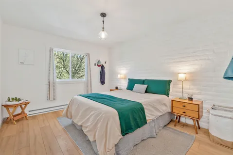 a bed room with a bed and a chair
