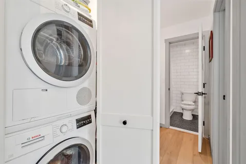 a view of a hallway with washer and dryer