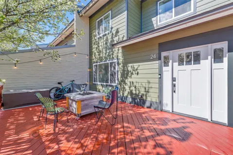front view of a house with a chairs and table in the patio