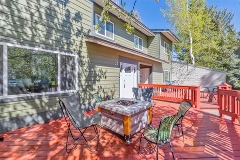 a view of a roof deck with furniture