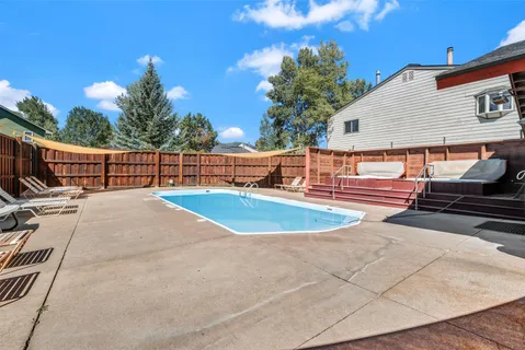 a view of a house with swimming pool and sitting area