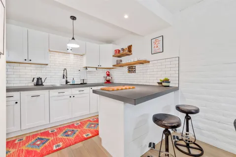 a kitchen with a sink cabinets and appliances