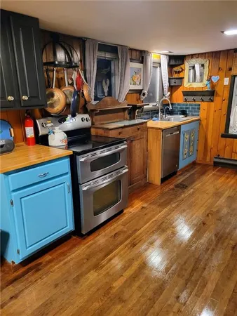 a kitchen with wooden floors and a sink