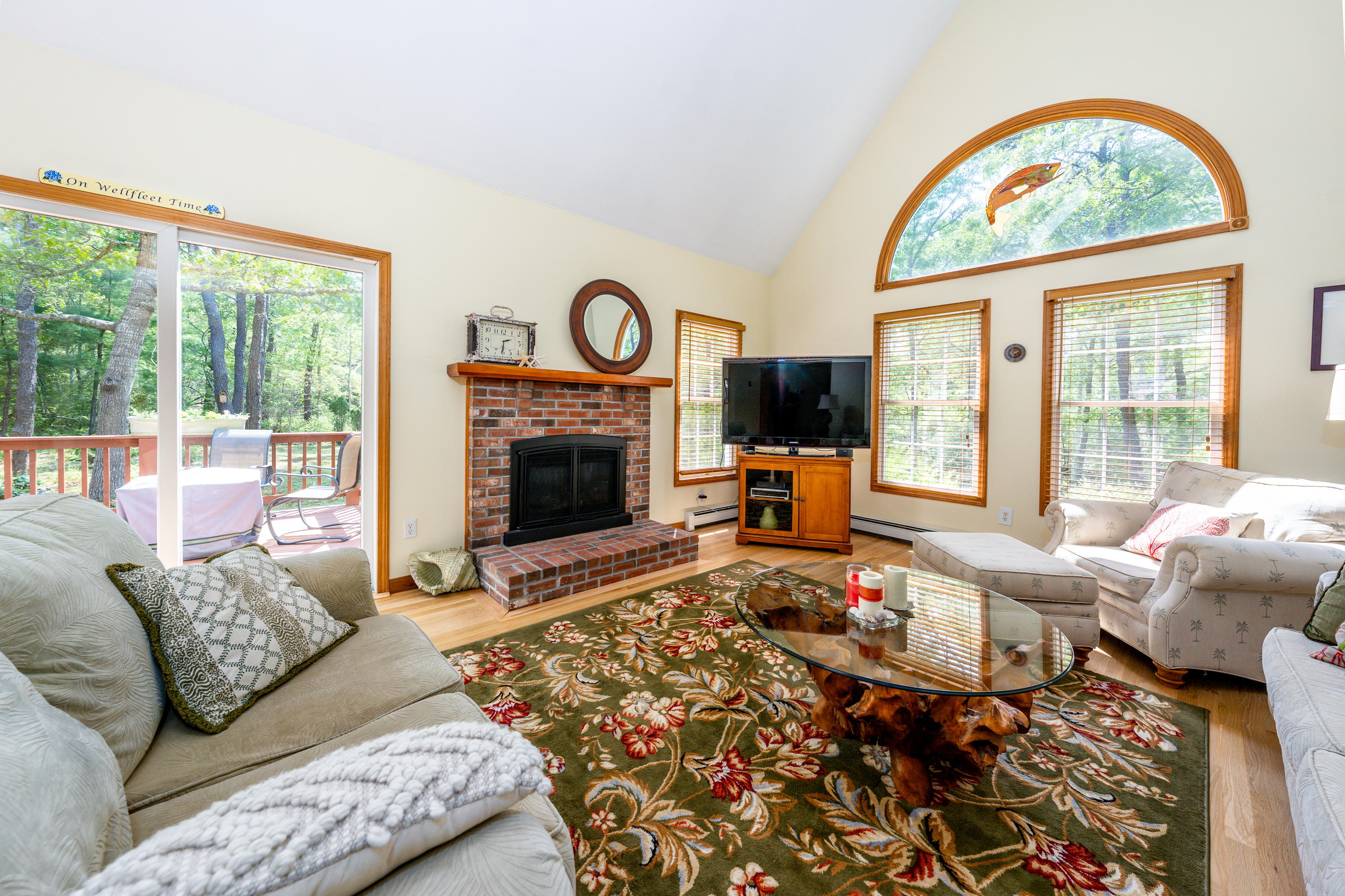 130 Browns Neck Road Wellfleet, MA 02667 - Photo 11 of 40 a living room with furniture large window and a fireplace