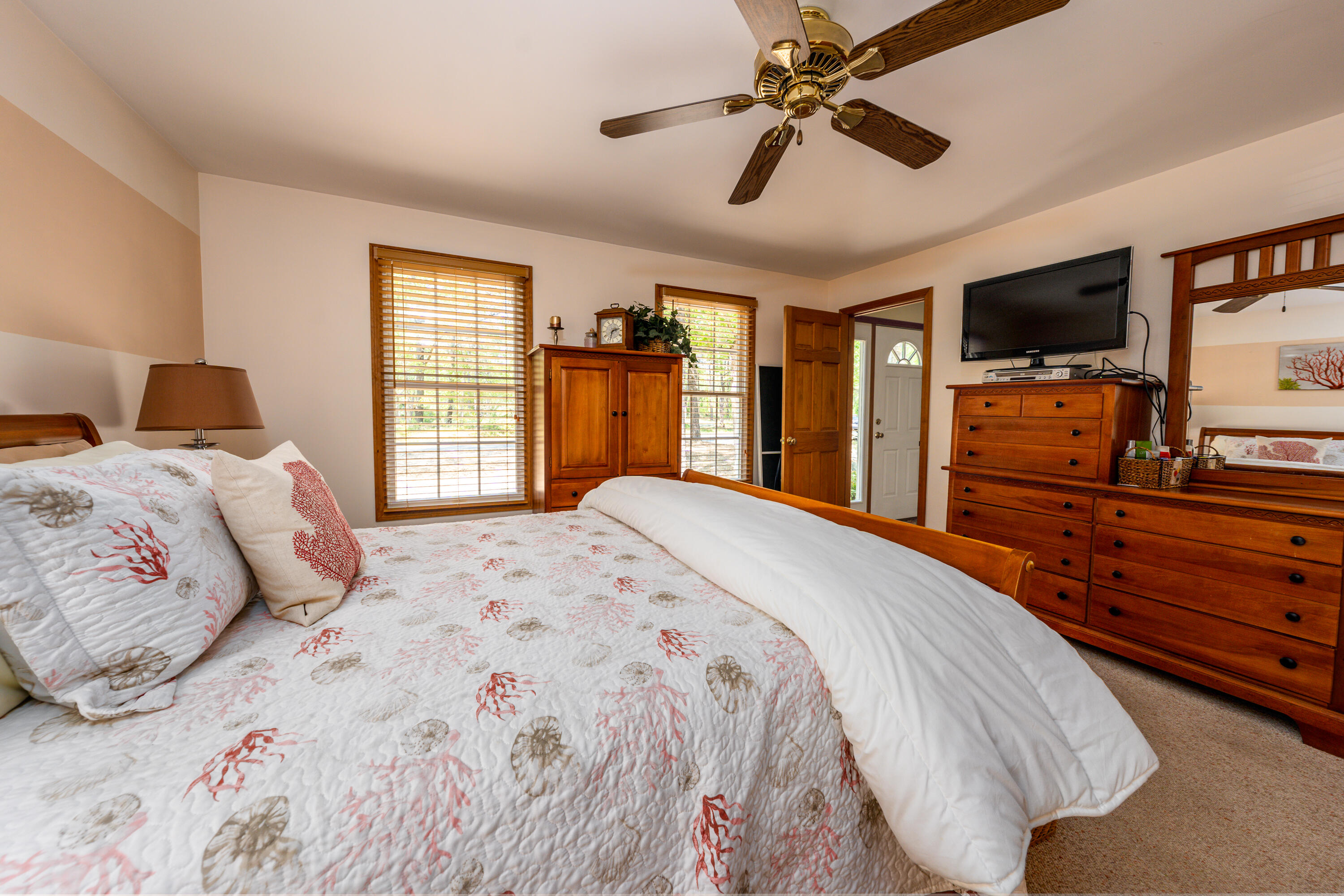 130 Browns Neck Road Wellfleet, MA 02667 - Photo 14 of 40 a bedroom with a large bed a flat tv screen and dresser
