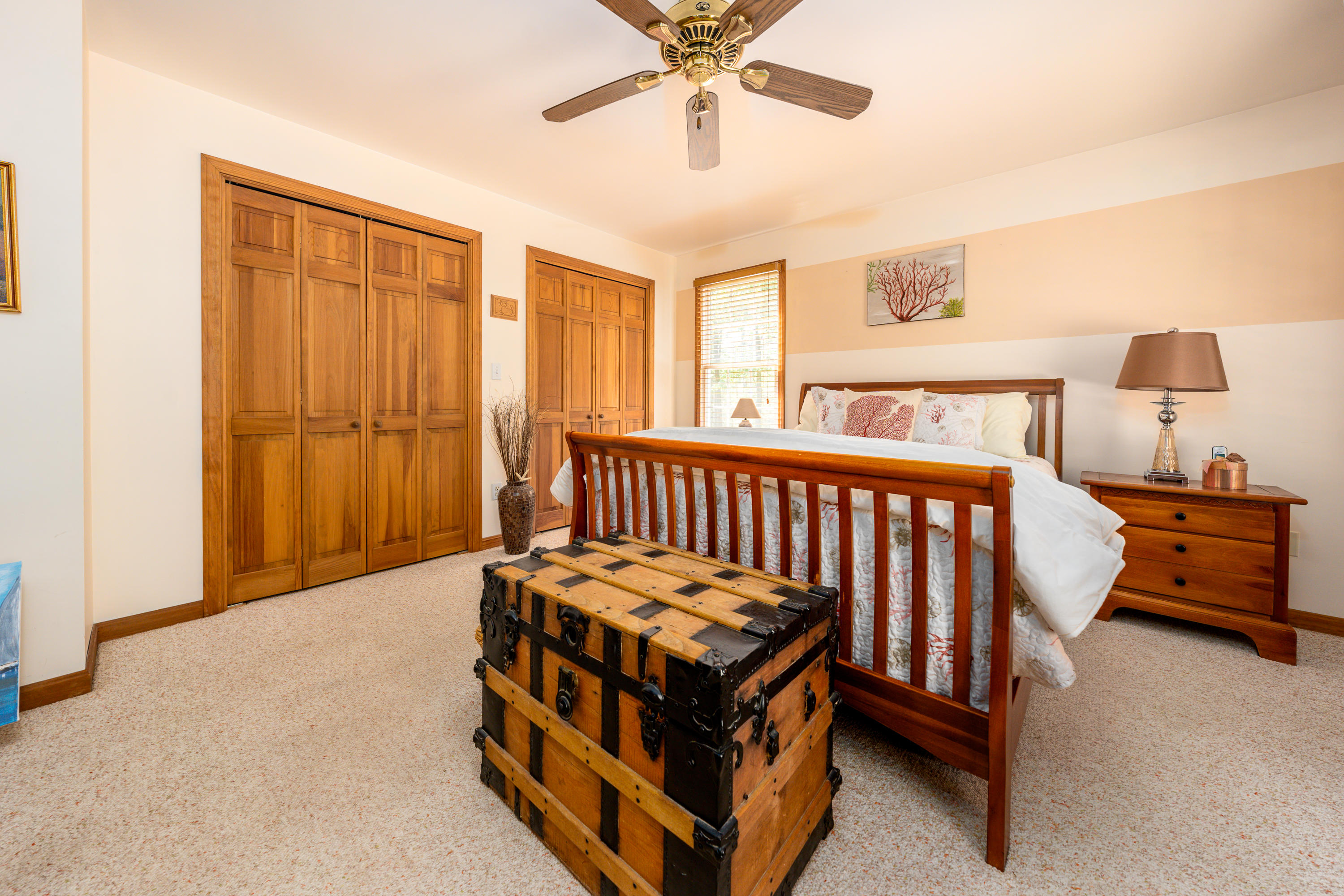130 Browns Neck Road Wellfleet, MA 02667 - Photo 15 of 40 a room with a bed and a chandelier