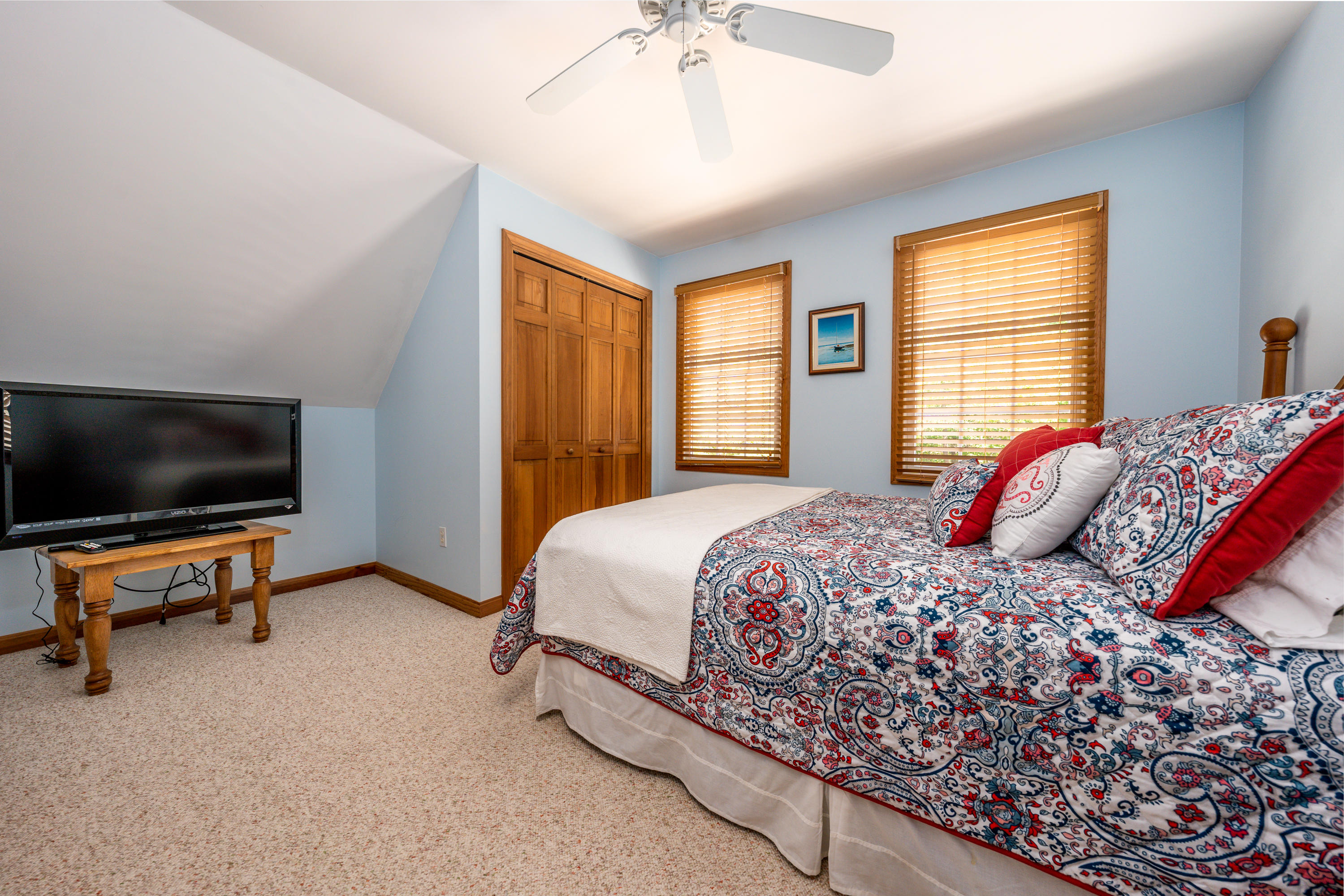 130 Browns Neck Road Wellfleet, MA 02667 - Photo 18 of 40 a bedroom with a bed and a flat screen tv