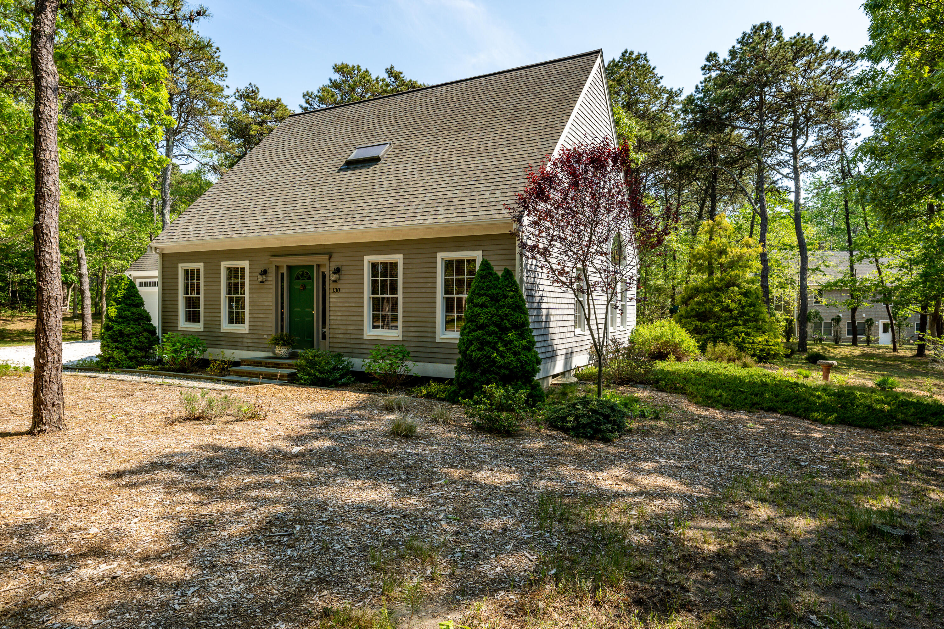 130 Browns Neck Road Wellfleet, MA 02667 - Photo 2 of 40 a front view of a house with a garden