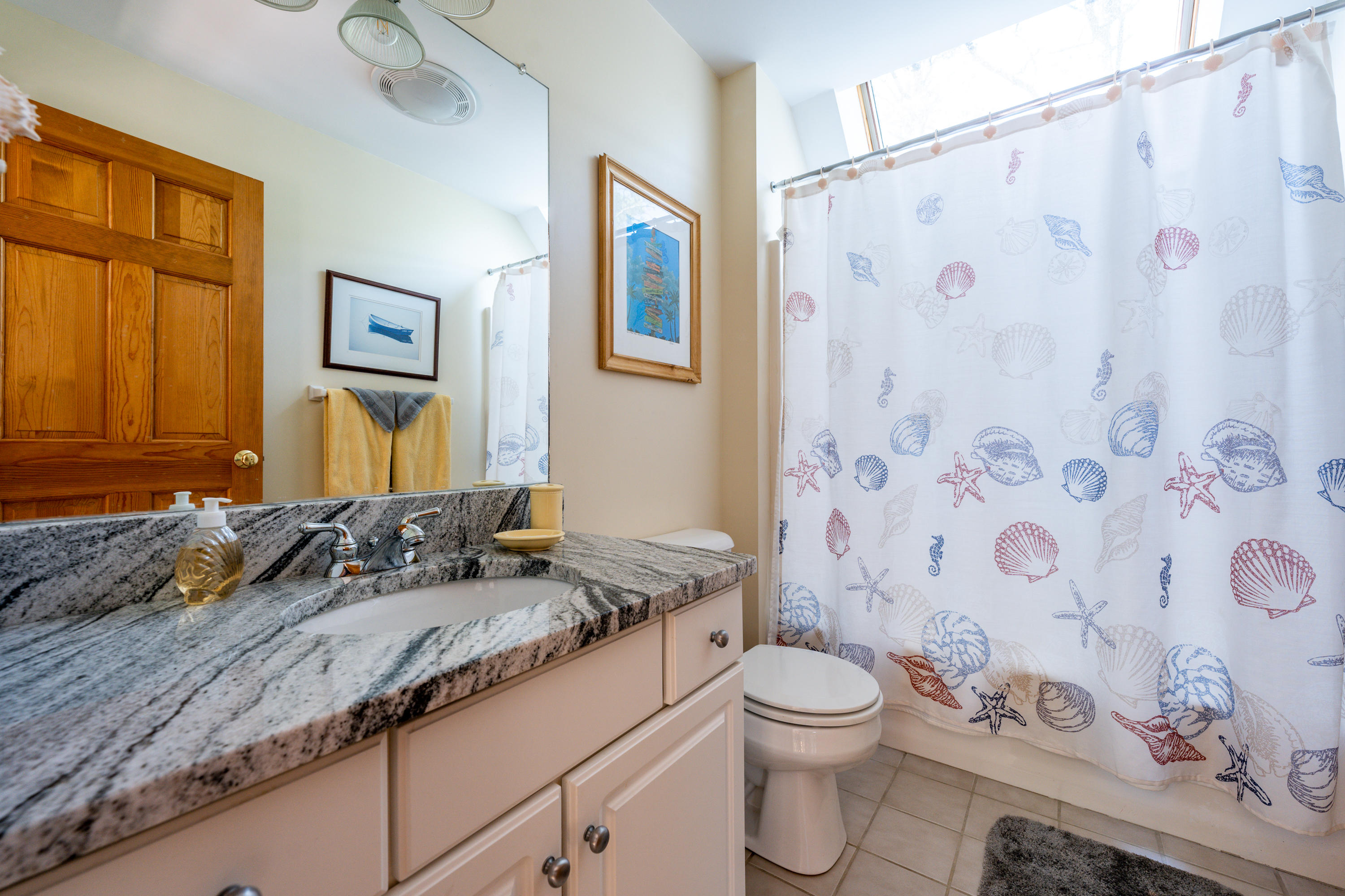 130 Browns Neck Road Wellfleet, MA 02667 - Photo 22 of 40 a bathroom with a granite countertop bathtub sink vanity mirror and toilet