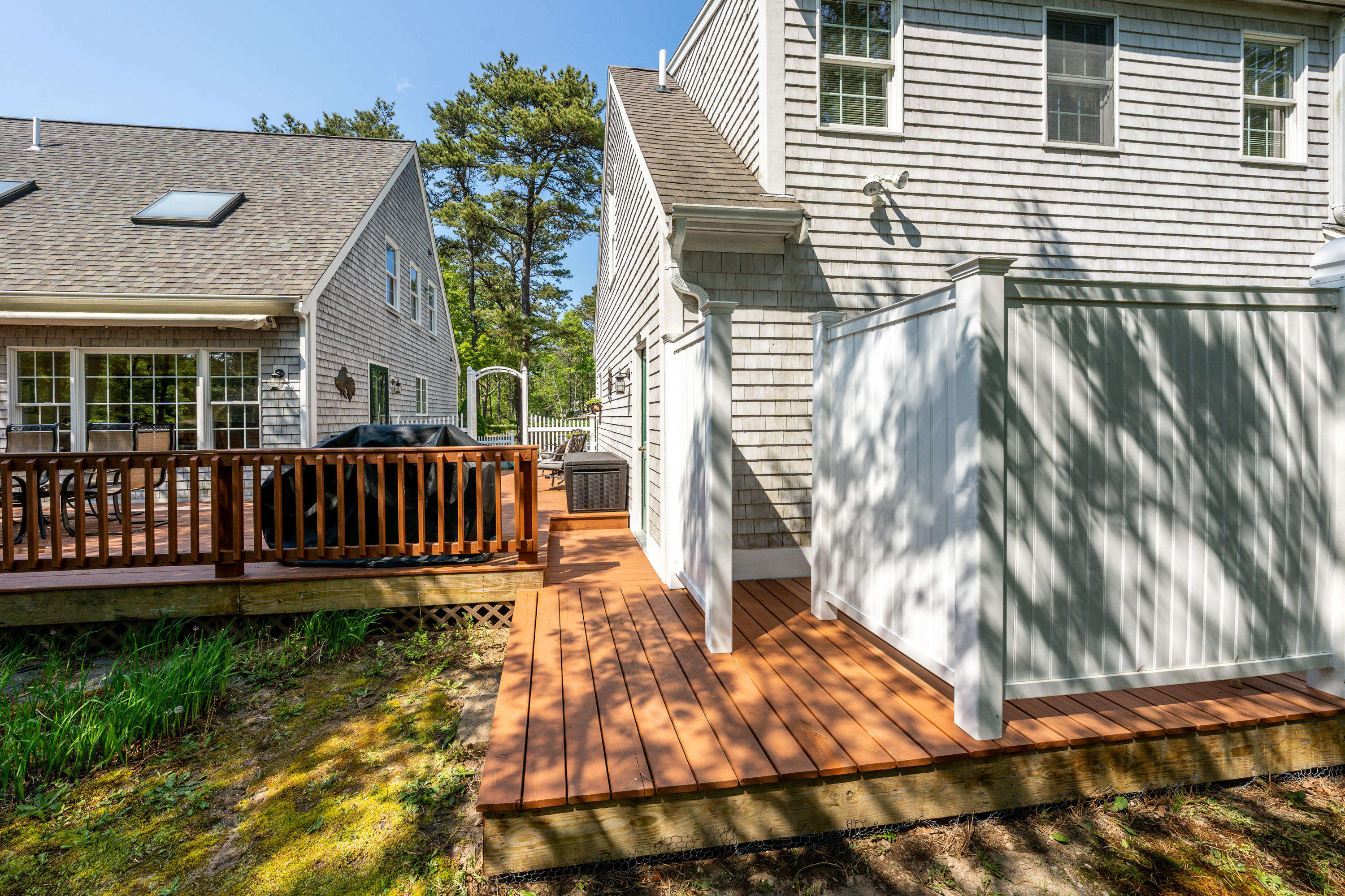 130 Browns Neck Road Wellfleet, MA 02667 - Photo 26 of 40 a view of a house with a wooden deck and furniture