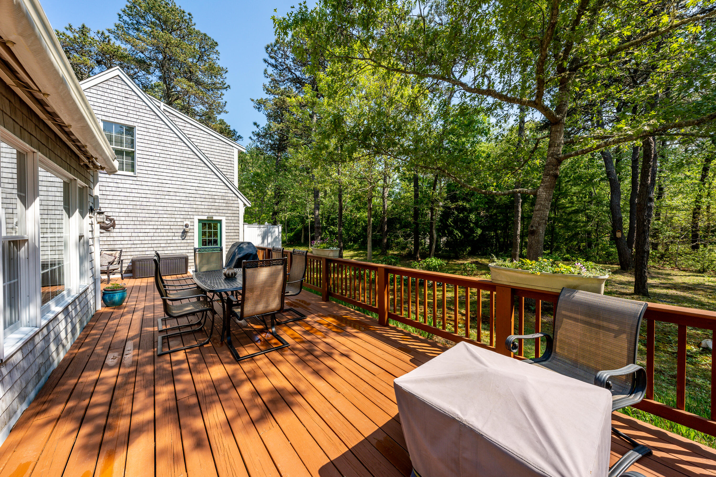 130 Browns Neck Road Wellfleet, MA 02667 - Photo 30 of 40 a view of a patio with couches table and chairs and wooden floor
