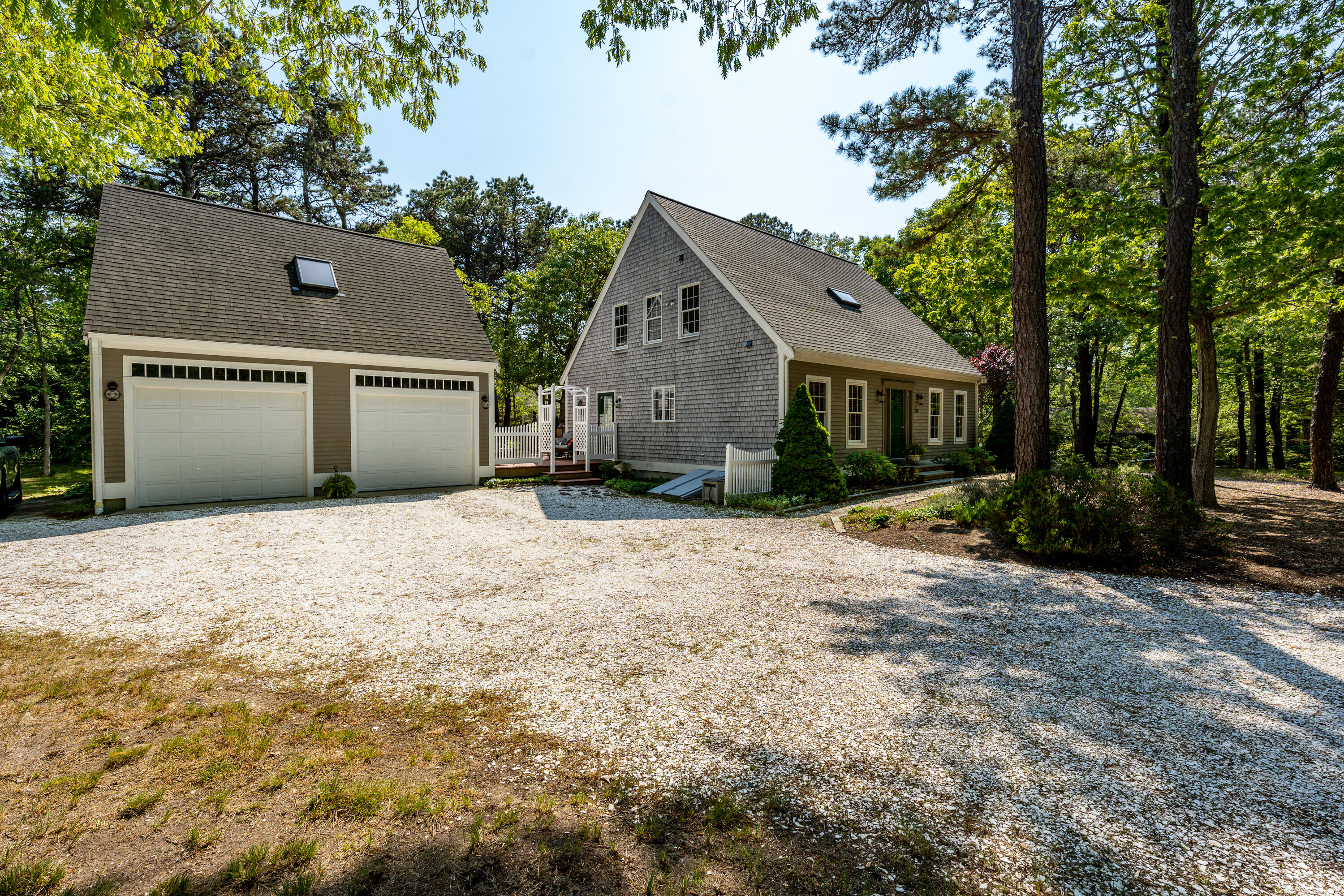 130 Browns Neck Road Wellfleet, MA 02667 - Photo 3 of 40 a front view of a house with a yard and garage