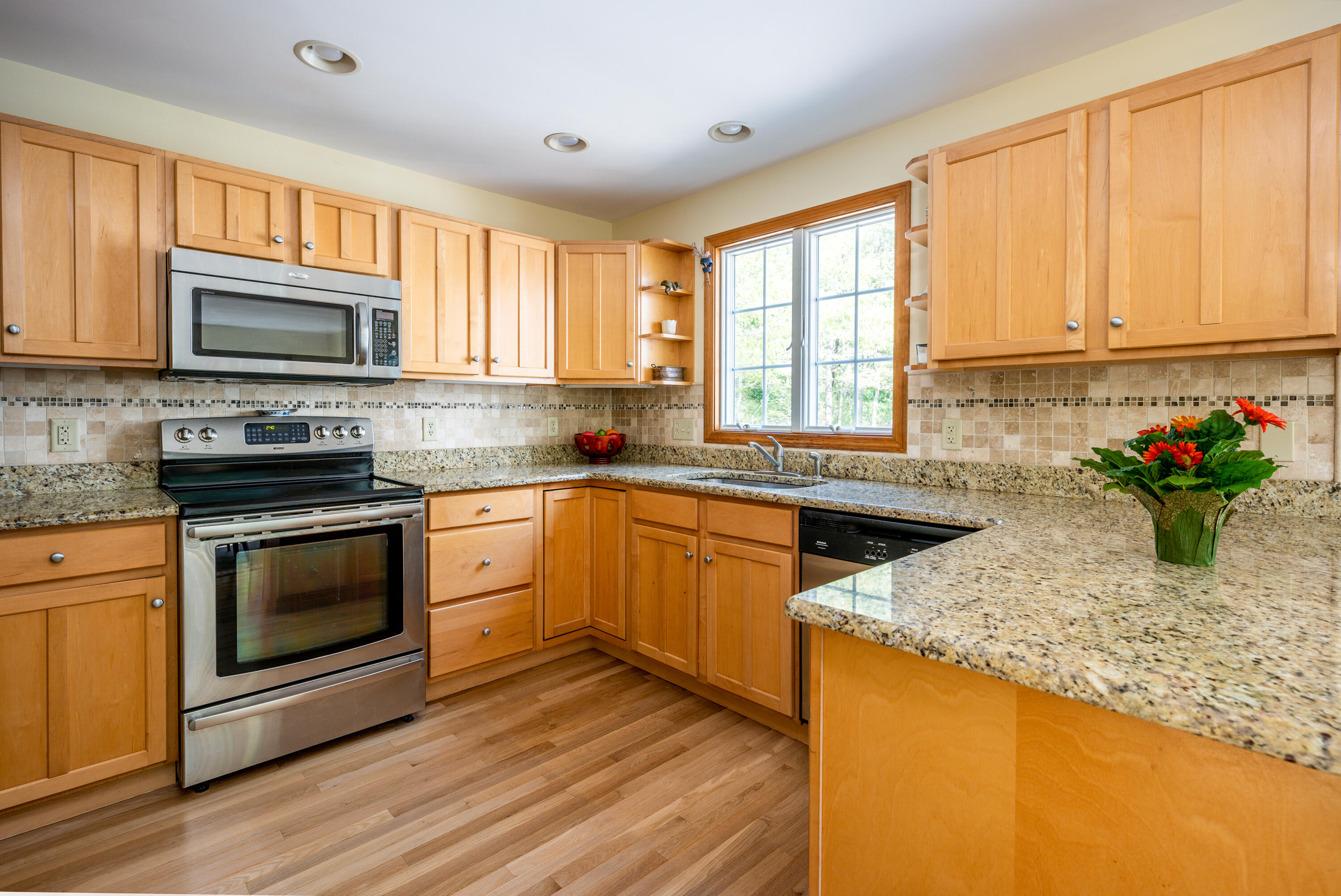 130 Browns Neck Road Wellfleet, MA 02667 - Photo 7 of 40 a kitchen with stainless steel appliances granite countertop a stove a sink and a microwave