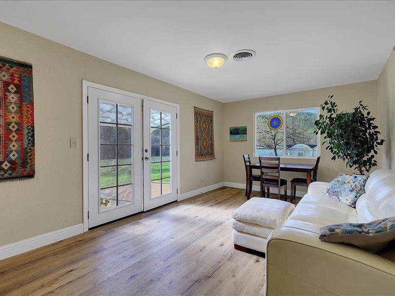 13001 Yuba-Nevada Road Dobbins, CA 95935 - Photo 30 of 63 a living room with furniture and a floor to ceiling window