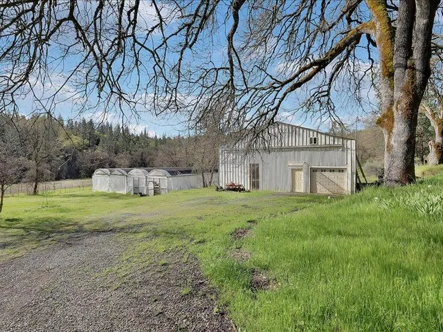 a view of an house with backyard space and garden