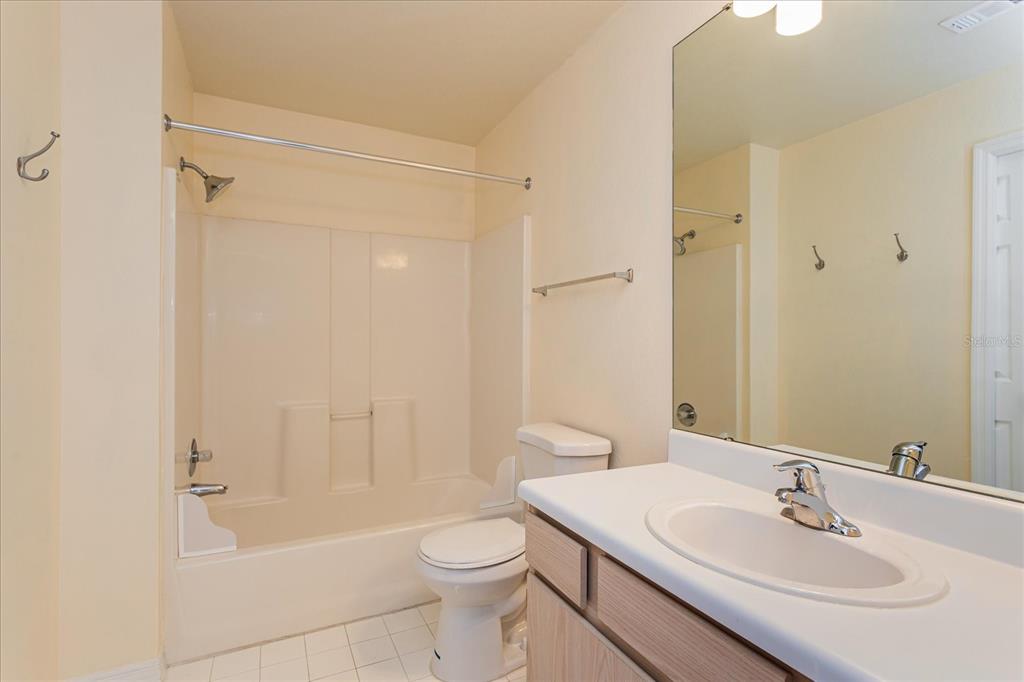 5455 Vineland Road, Unit 3214 Orlando, FL 32811 - Photo 12 of 25 a bathroom with a sink a toilet and shower