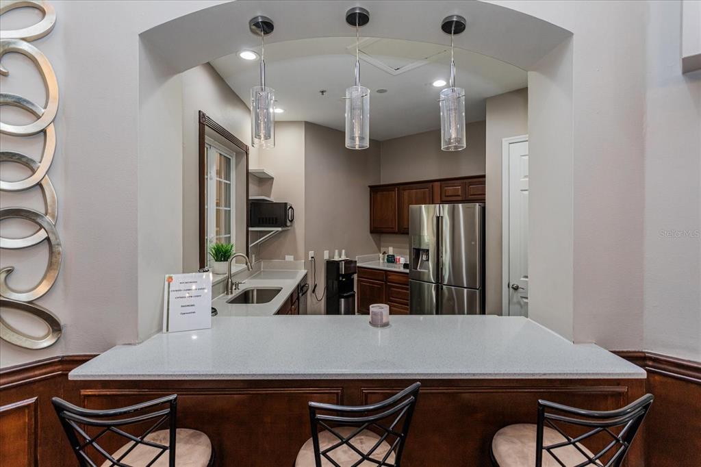 5455 Vineland Road, Unit 3214 Orlando, FL 32811 - Photo 19 of 25 a table with chairs and a stove top oven