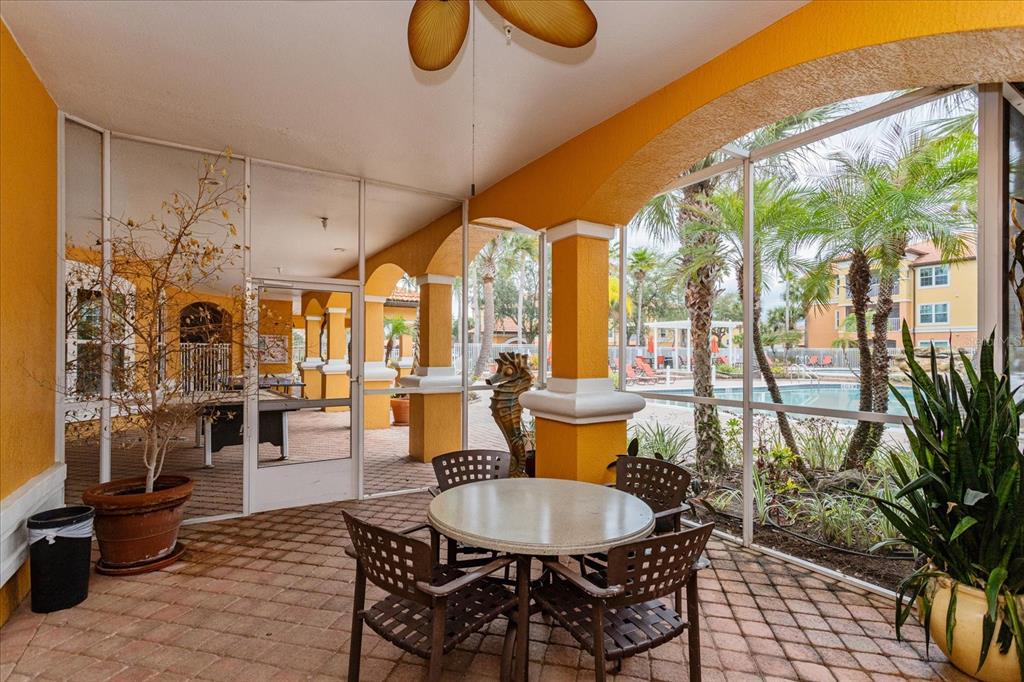 5455 Vineland Road, Unit 3214 Orlando, FL 32811 - Photo 21 of 25 a dining room with furniture a chandelier and wooden floor