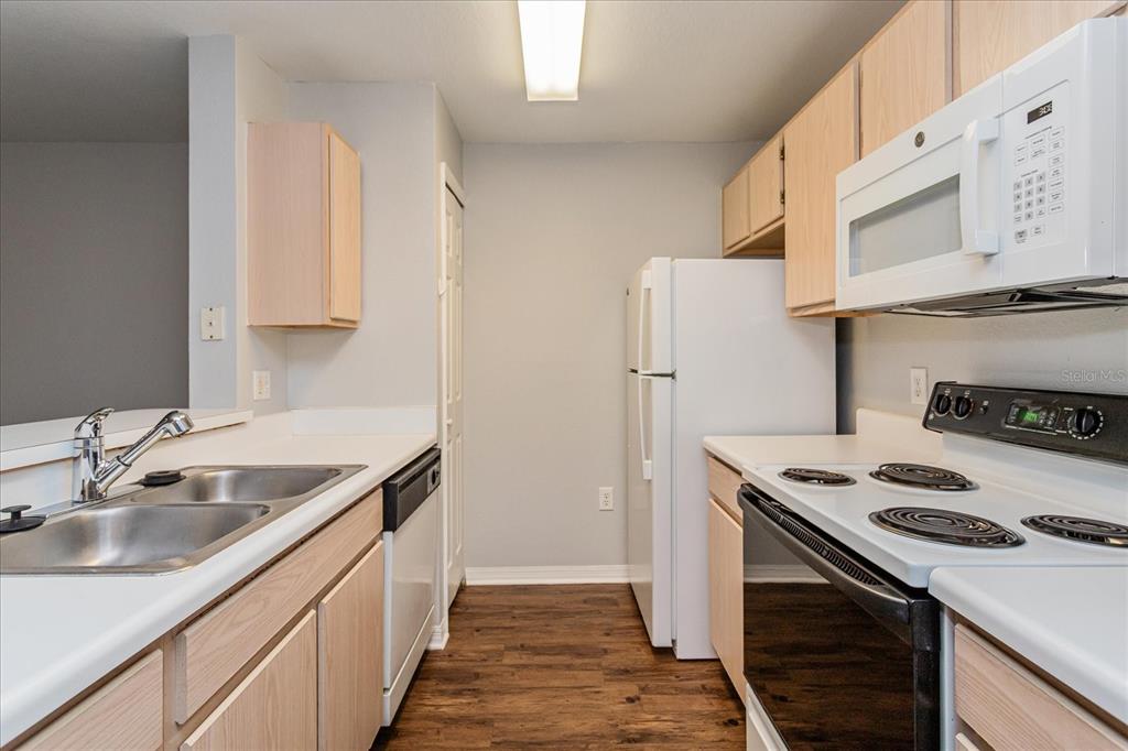 5455 Vineland Road, Unit 3214 Orlando, FL 32811 - Photo 7 of 25 a kitchen with stainless steel appliances granite countertop a sink stove and refrigerator