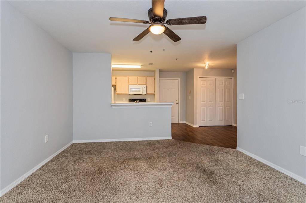 5455 Vineland Road, Unit 3214 Orlando, FL 32811 - Photo 9 of 25 en empty room with windows and ceiling fan