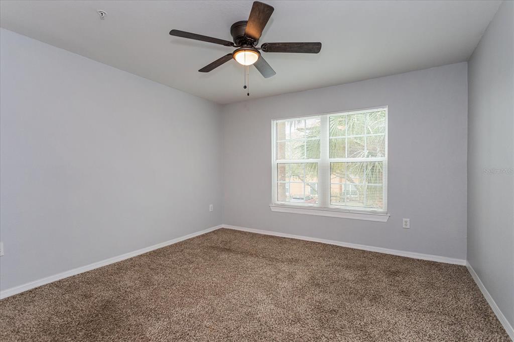 5455 Vineland Road, Unit 3214 Orlando, FL 32811 - Photo 10 of 25 an empty room with a window and a fan