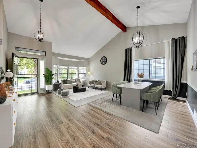 a living room with fireplace furniture and a large window
