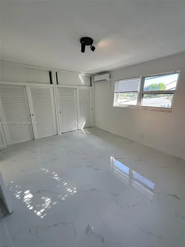 an empty room with a empty space and windows