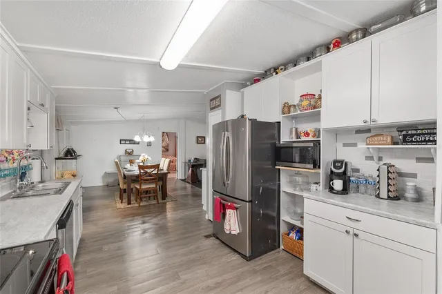 a kitchen with white cabinets and counter space