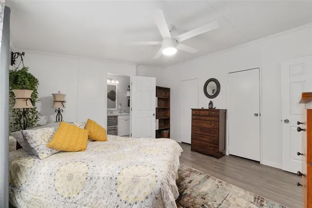 a bedroom with furniture and a flat screen tv