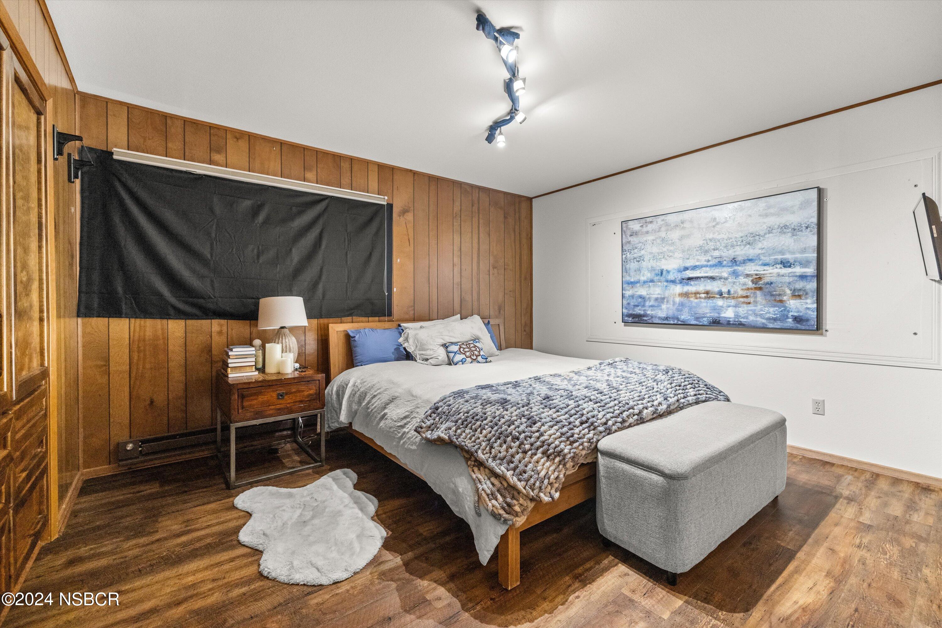 4281 Highway 246 Lompoc, CA 93436 - Photo 29 of 60 a bedroom with a bed and wooden floor