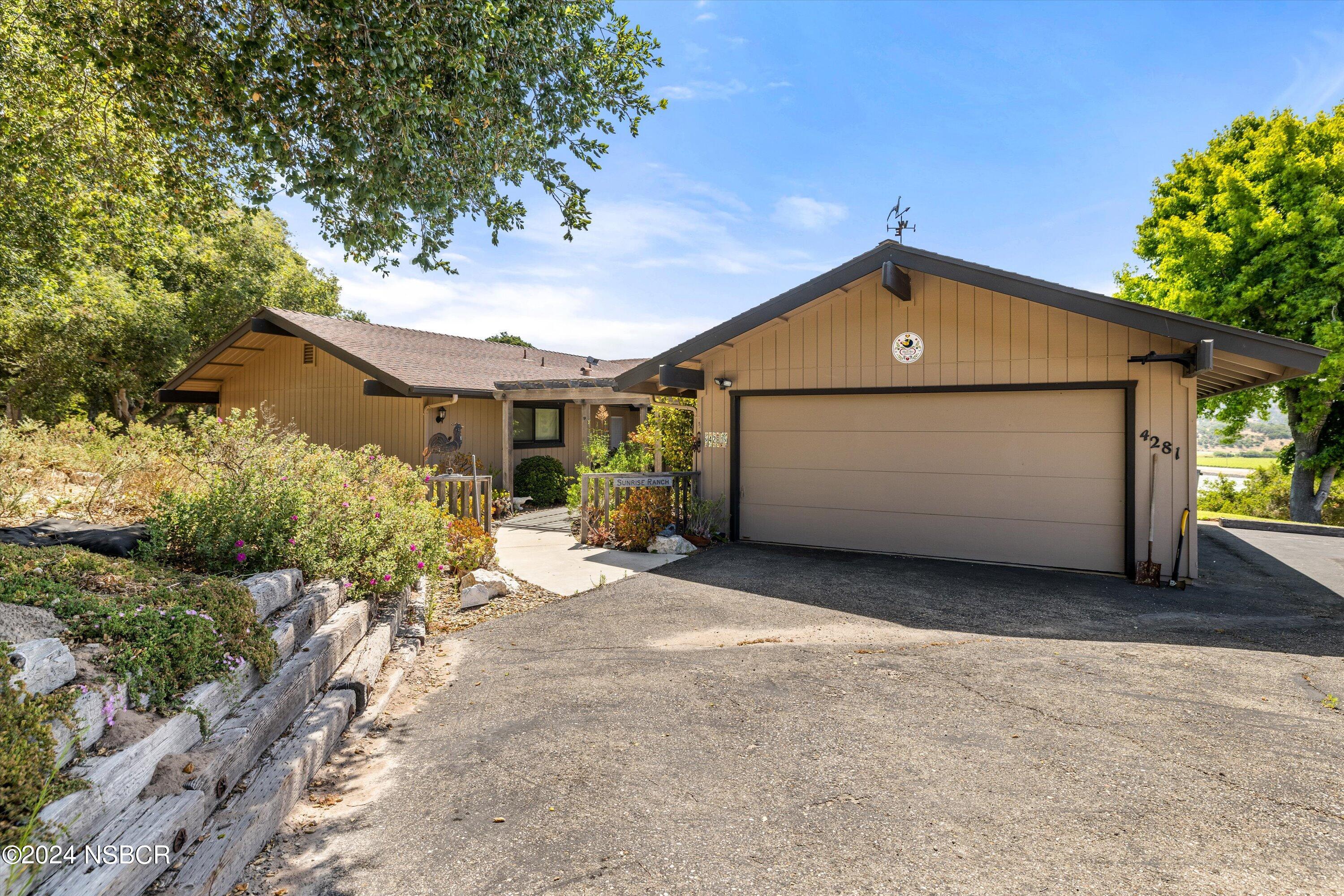 4281 Highway 246 Lompoc, CA 93436 - Photo 3 of 60 a front view of a house with a yard and garage