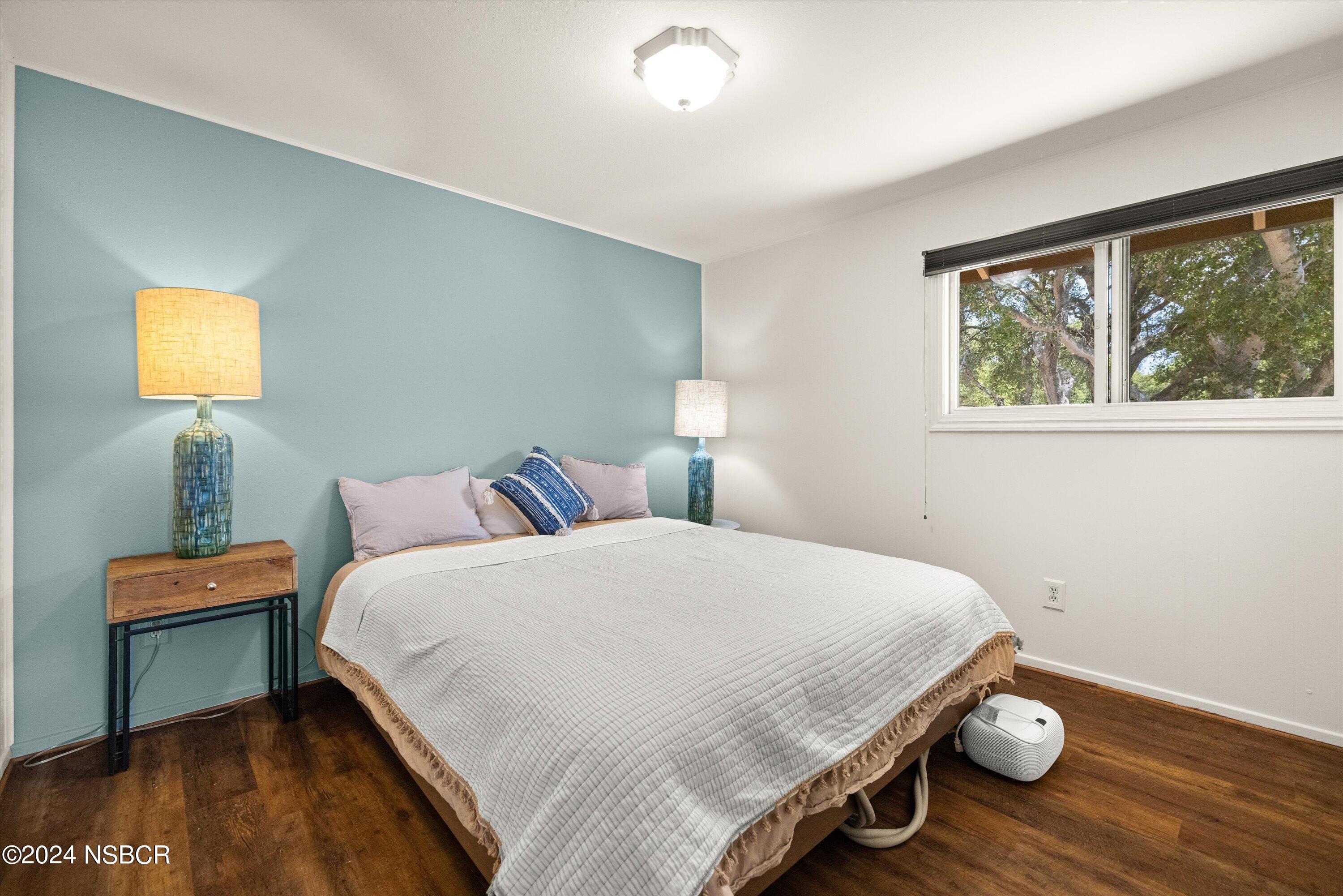 4281 Highway 246 Lompoc, CA 93436 - Photo 31 of 60 a bedroom with a bed and wooden floor