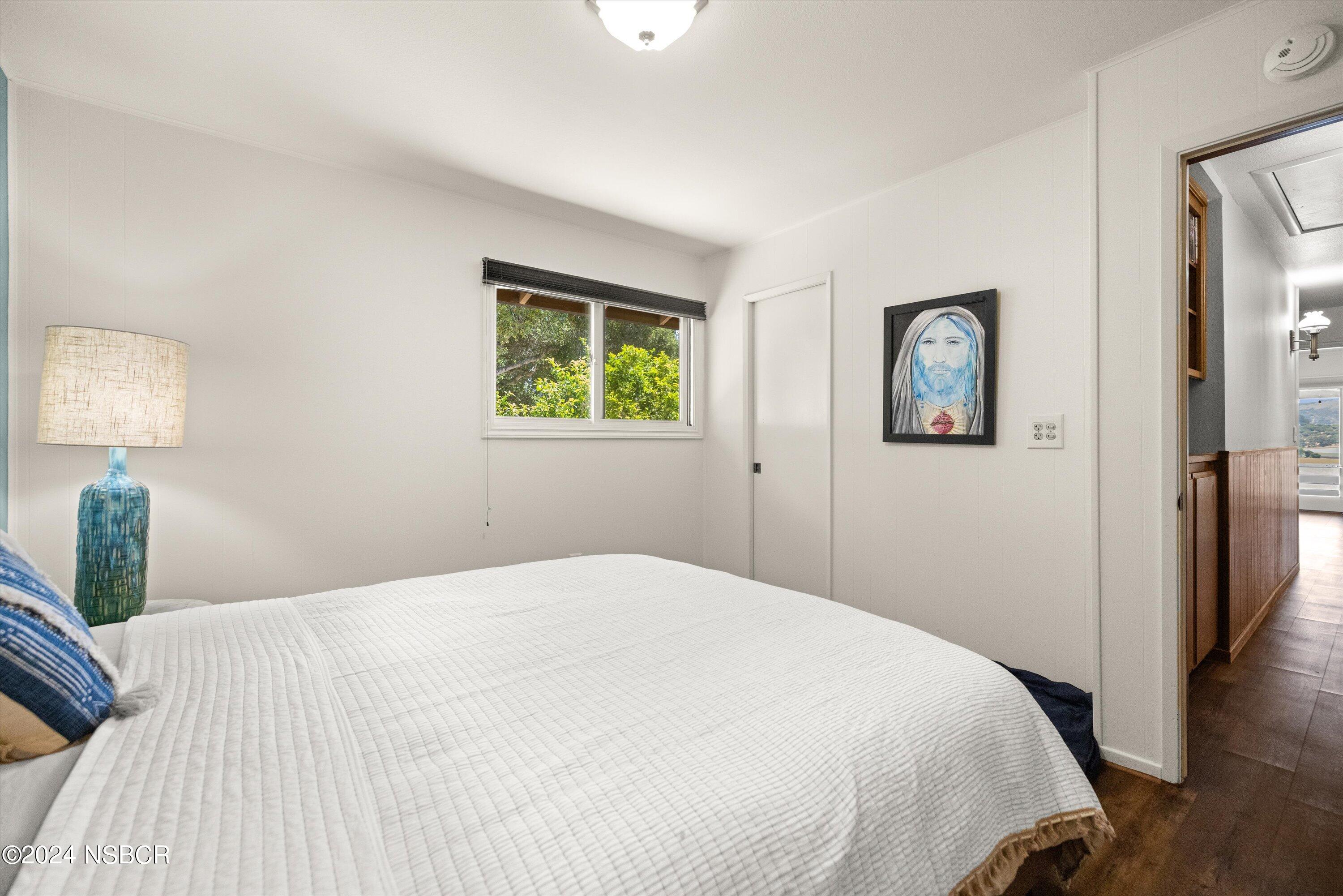 4281 Highway 246 Lompoc, CA 93436 - Photo 32 of 60 a bedroom with a bed and a painting on the wall