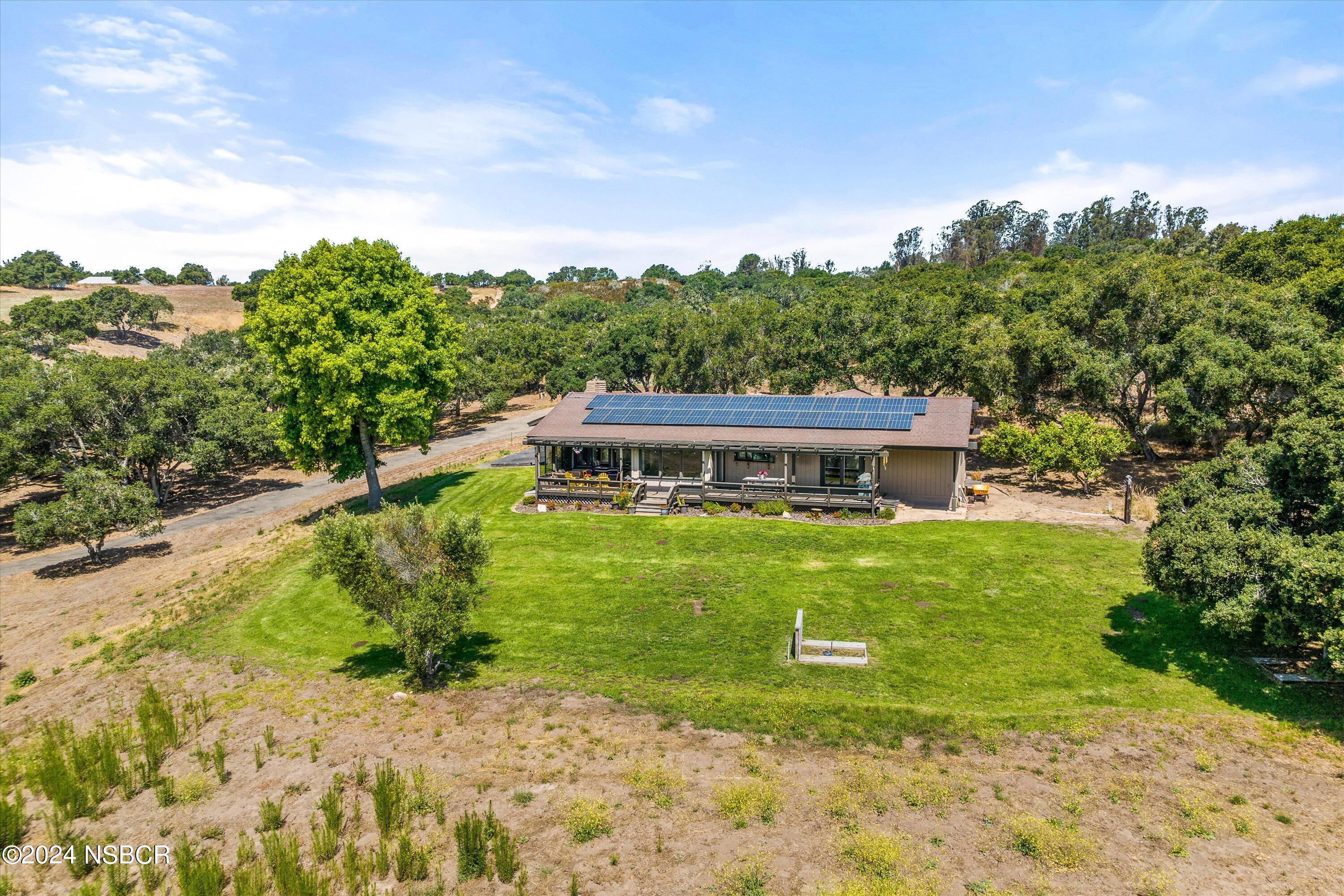 4281 Highway 246 Lompoc, CA 93436 - Photo 44 of 60 a view of a house with a big yard and large tree