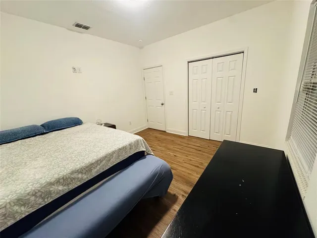 a bedroom with a bed and dresser