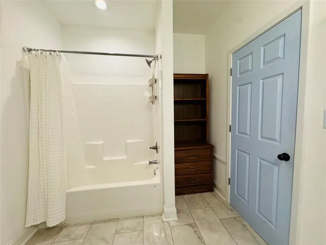 a bathroom with a bathtub and a shower
