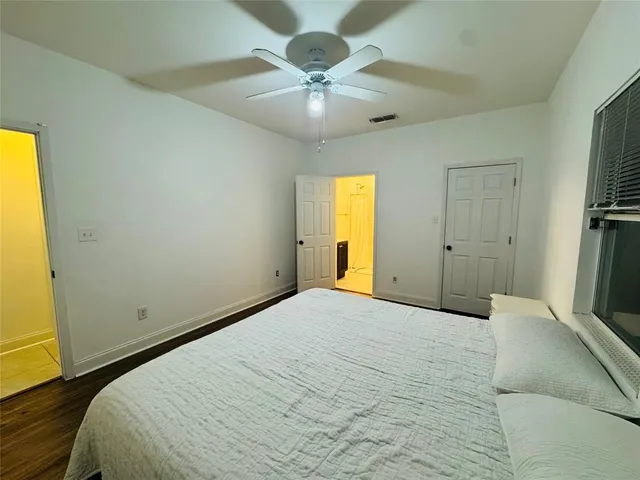 a bedroom with a bed and a large window
