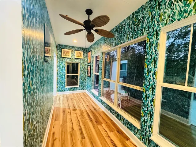 a view of swimming pool with a large window and chandelier