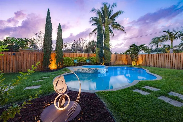 a view of a backyard with swimming pool and deck