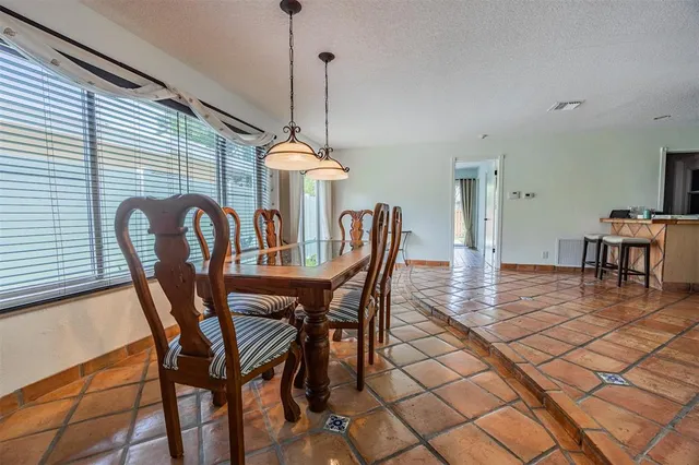 a kitchen with a table chairs and a refrigerator