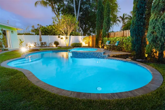 a view of a swimming pool with an outdoor space and seating area