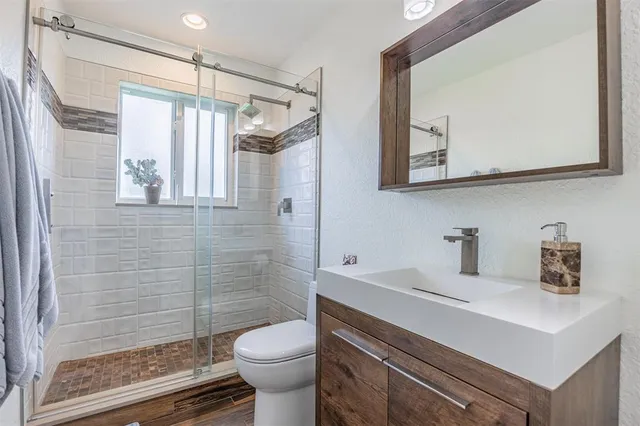 an aerial view of residential houses with outdoor space and lake view