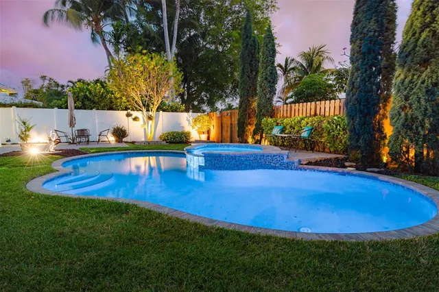 a view of a backyard with swimming pool