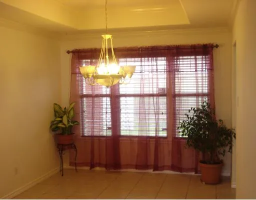 a view of a room with a window and chandelier