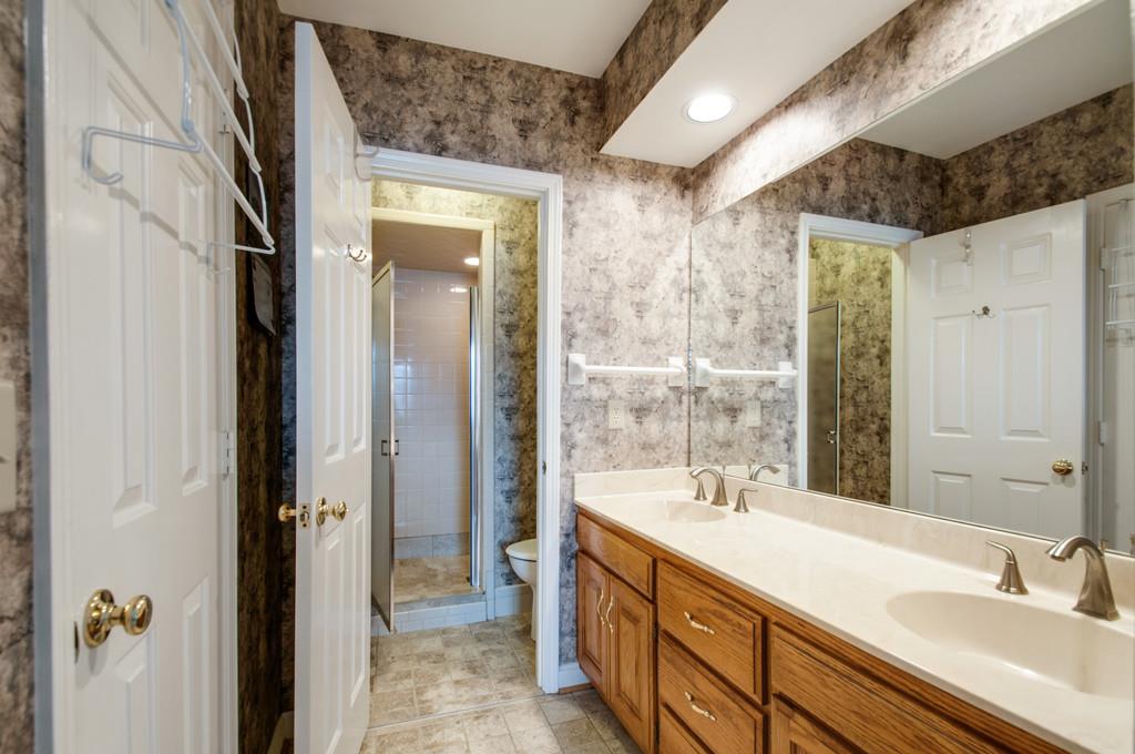 520 General George Patton Road Nashville, TN 37221 - Photo 22 of 30 a bathroom with a double vanity sink a mirror and a shower