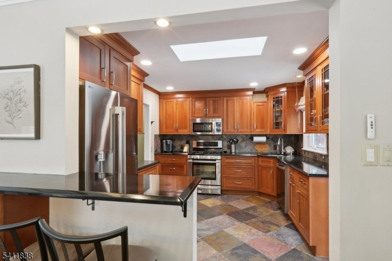 4 Southview Road Randolph, NJ 07869 - Photo 9 of 30 a kitchen with refrigerator and chairs