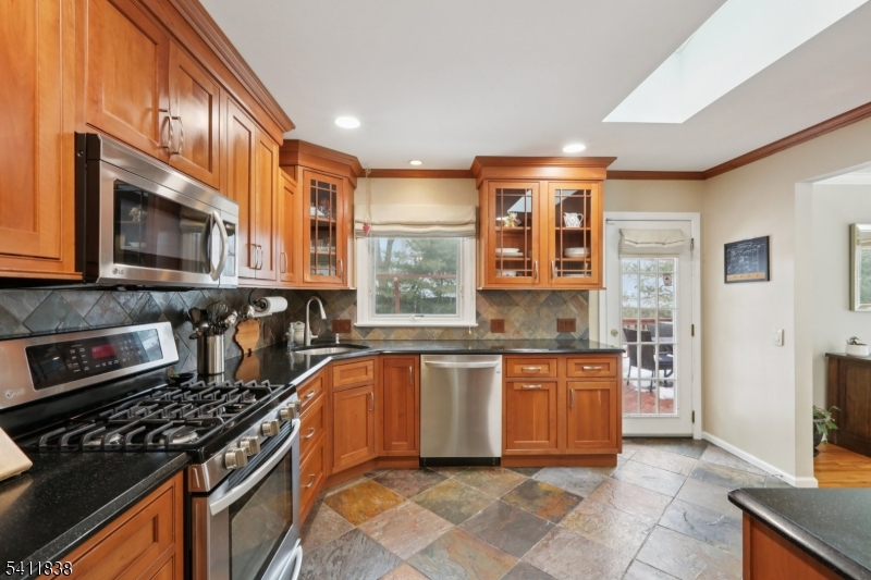 4 Southview Road Randolph, NJ 07869 - Photo 10 of 30 a kitchen with stainless steel appliances granite countertop a stove top oven a sink dishwasher a dining table and chairs